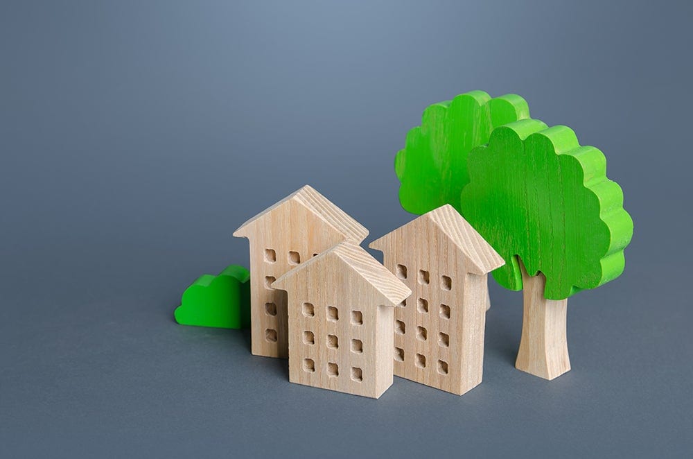 communities of concern - wooden block houses and trees