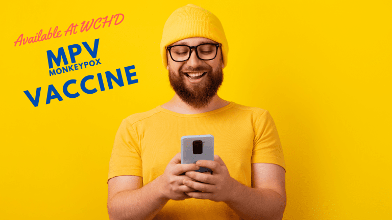 MPV (monkeypox) vaccine - man smiling at his phone