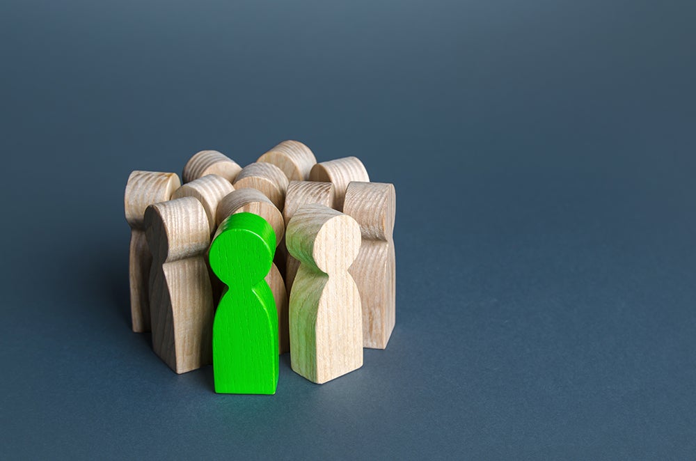 communities of concern - wooden block people with one green