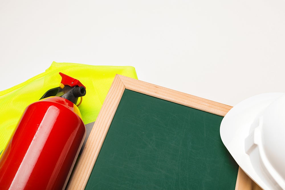 public health emergency preparedness - fire extinguisher and hard hat with chalkboard