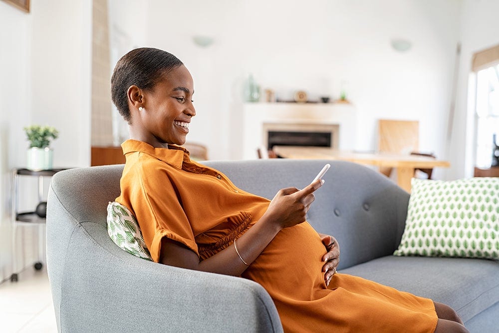 Personal Health Services (PHS)/Public Health Nursing - smiling pregnant woman on her phone
