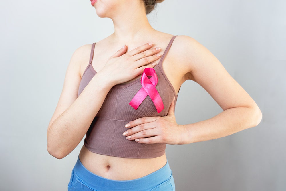 Personal Health Services (PHS)/Public Health Nursing - woman with pink breast cancer ribbon on chest